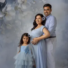 A picture-perfect family portrait. Everyone is coordinated in beautiful shades of blue, creating a cohesive and timeless image.