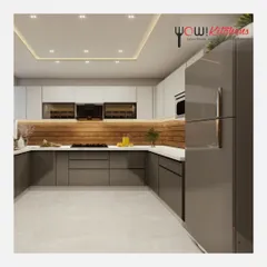 A wider view of this sleek, modern kitchen, showing the integrated refrigerator and the clean, handleless design that defines its minimalist aesthetic. The layout is both spacious and efficient.