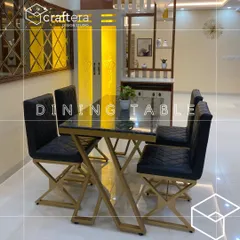 I designed this contemporary dining set with a black marble-top table and quilted leatherette chairs. The gold-finished geometric legs of the table and chairs add a touch of luxury and tie the space together.