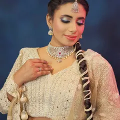 This look is all about ethereal glam. A beautiful white chikankari lehenga is paired with a silver and blue cut-crease eye makeup, perfect for a modern bride who wants a touch of drama.
