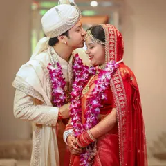 A tender kiss on the forehead during the wedding ceremony. This classic, romantic gesture is a beautiful expression of love and care between the couple.