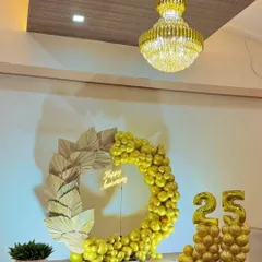 Another view of the stunning golden 25th anniversary setup, showing how it looks in a grand hall with a chandelier. It’s perfect for a large party.
