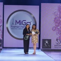 A moment of immense pride, being felicitated on stage at the MIGA Fashion Show. This award is a culmination of years of dedication, and I'm so grateful for the opportunity and the support from my family and students.