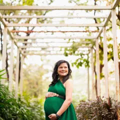 The elegance of motherhood. This mama-to-be in a stunning emerald green gown looks so serene and powerful standing in a beautiful garden path.