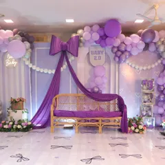 Bows are so in trend, and I loved designing this chic and modern baby shower around them. The combination of rich purple draping, a cascade of balloons, and custom details created a sophisticated yet playful atmosphere for the parents-to-be.