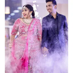 A grand entrance for the reception. The couple walks in hand-in-hand through a cloud of fog, creating a magical and dramatic effect.