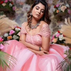 A close-up of the off-shoulder bodice of the pink ball gown, set against a beautiful floral backdrop.