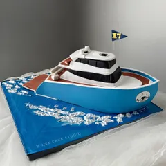 A 5 kg yacht cake, sculpted and detailed to look like the real thing, sailing on an edible sea.