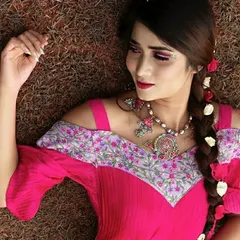 A detailed shot of the embroidered off-shoulder neckline on the fuchsia pink dress. I love mixing prints and textures to create a unique piece. This outfit is perfect for a bridesmaid or a guest at a destination wedding.
