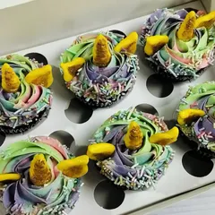 These magical unicorn cupcakes are one of my most requested designs for kids' parties. Each chocolate cupcake is decorated with a beautiful pastel rainbow swirl of buttercream, edible sprinkles, and a golden fondant horn and ears, making them a truly enchanting treat.