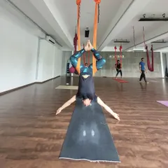 An upside down perspective from our aerial yoga class. Inversions like this help decompress the spine and bring fresh oxygen to the brain, leaving you feeling refreshed and energized.