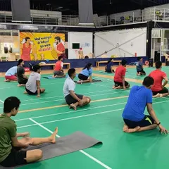 A wide view of a stretching and mindful movement session in progress at our Sarjapura academy. We utilize our court space for these activities to build a holistic training environment where every aspect of athlete well-being is addressed.