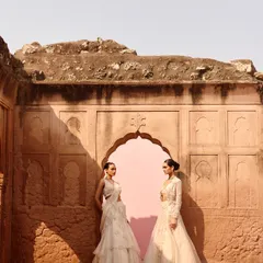 Two stunning ivory looks from the Awigna campaign, set against a beautiful rustic backdrop. Perfect inspiration for a bride and her sister or bridesmaid.