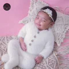 A heart-melting smile from a sleeping newborn, showcasing the pure joy and innocence of a new life.