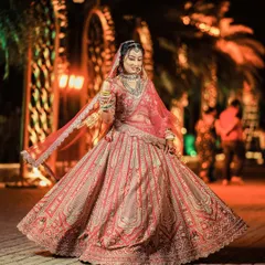 Every bride deserves her moment to shine. This portrait captures the pure joy and elegance of a bride in her stunning wedding lehenga, a timeless image of grace and happiness.