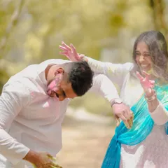 This candid shot captures the energy and laughter of a couple mid-play, dodging and throwing colored powder during their fun pre-wedding session.