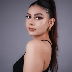 A classic glam look with a sharp wing, warm-toned eyeshadow, and a sleek high ponytail. This is a versatile style we teach for parties and events.