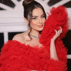 A soft yet glamorous look for a cocktail event. This ruffled red gown is pure drama and elegance, styled with a clean high bun and sparkling diamond jewelry to let the outfit do all the talking.