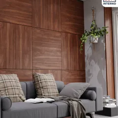 A warm and inviting living room featuring a wall paneled with our natural wood veneer. Paired with a comfortable grey sofa and plaid cushions, this design creates a cozy yet sophisticated atmosphere.
