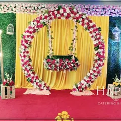 We design elegant stage setups like this one, featuring a circular floral arch that frames the baby's cradle. The combination of a lush greenery wall, soft drapery, and warm lighting creates a beautiful photo backdrop.