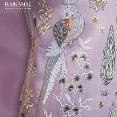 This close-up highlights the exquisite threadwork on a pastel Jodhpuri suit. The design features a beautifully detailed bird perched on a branch, showcasing the fine craftsmanship and artistic storytelling I bring to my ethnic wear collections.