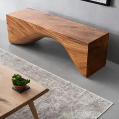 A close-up of the sculptural wooden bench in Zen House. Its organic curves provide a beautiful contrast to the clean lines and flat planes of the surrounding architecture and furniture.