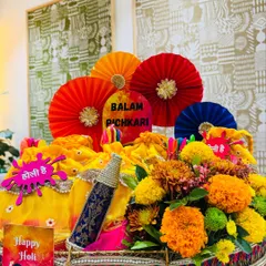 Holi is a festival of pure joy, and this 'Balam Pichkari' hamper captures that energy. I moved beyond the usual dry fruit box, presenting them in festive yellow potlis alongside colorful pinwheels, a decorative pichkari, and fresh marigolds for a truly desi celebration.