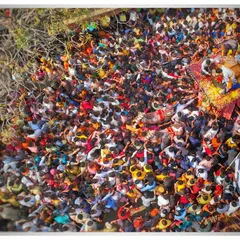 A top down photograph looking directly into the heart of the Khatu Shyam Ji Rath Yatra. This perspective transforms the dense crowd into a vibrant tapestry of color and movement, capturing the overwhelming scale of the festival.