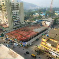 Another perspective of the urban construction site, highlighting its proximity to adjacent buildings and traffic flow. This helps in logistics planning and creating marketing materials that showcase the location.
