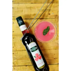 A Raspberry and Mint Daiquiri, pictured from above to show its vibrant color. This cocktail is a simple yet elegant mix of white rum, fresh lime, mint, and raspberry syrup, served chilled.