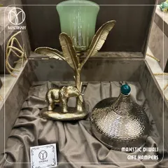Our Majestic Diwali Gift Hamper, featuring a stunning gold-finished elephant candle holder and an ornate hammered-metal jar. This is luxury gifting designed to create cherished memories during the festival of lights.