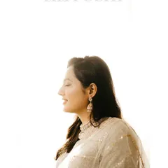 A serene solo portrait of the bride-to-be during her roka ceremony. The soft, natural light highlights her elegance and happy expression.