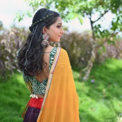 A profile shot showing the intricate details of the hairstyle and jewelry that complete the traditional Garba look. It's all about celebrating our rich heritage.