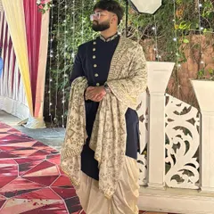 This client is rocking our navy blue Indo-Western outfit with dhoti pants and an embroidered shawl. It's a stylish and comfortable choice for any wedding function.