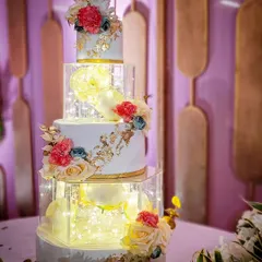 A closer look at this stunning four-tier wedding cake with illuminated spacer tiers. The fairy lights inside the transparent sections created a magical glow for the evening reception.