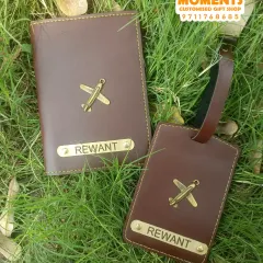 A matching set of a passport cover and luggage tag, both customized with the name 'Rewant' and an airplane charm. This is a very popular gift for travelers.