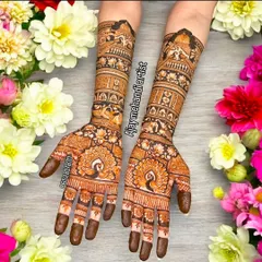 This beautiful design features prominent peacock motifs on the palms, a symbol of grace and beauty in Indian culture. The arms are covered in traditional bands of patterns.