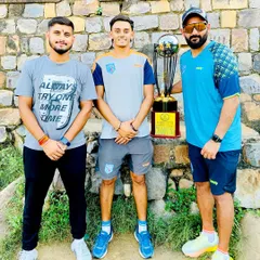 Another angle of the coaching team with the trophy. We lead by example.
