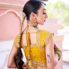 This side profile shows off the elegant drop earrings and the unique hair accessory used to decorate the braid. I believe in styling a complete look, right down to the smallest details.