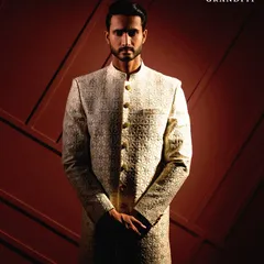 A closer look at the artistry of our craftsmanship. This image highlights the detailed, textured embroidery on a bespoke sherwani, a testament to our commitment to sartorial excellence.