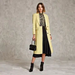 This 'Modern Maverick' concept showcases a pale yellow longline blazer with a geometric print blouse and a black midi skirt. It demonstrates how I can layer different pieces in AI to create a fully styled, cohesive outfit.