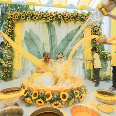 A Haldi ceremony is all about joy and vibrant moments. We love creating fun, interactive setups like this one, complete with traditional elements and plenty of room for playful splashing, ensuring your photos are as lively as the celebration itself.