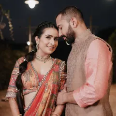 An intimate portrait from a carnival-themed wedding event. The warm lighting and the couple's close embrace create a romantic atmosphere amidst the vibrant celebration.