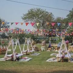 Imagine your next celebration set up like this. We create beautiful, relaxed picnic and party settings with charming teepees and colorful bunting, perfect for making memories in the open air.