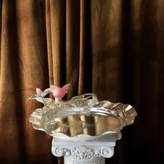 Here, the gentle energy of rose quartz meets the whimsical form of a bird, all set against the cool shine of a silver-plated tray. I designed this piece to be a regal and charming centerpiece, perfect for serving delicacies or simply admiring.