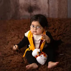 The cutest little wizard in training. He's got his wand, his owl, and a little bit of magic sparkling around him in this fun Harry Potter setup.