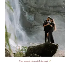 A romantic and magical moment captured during a pre-wedding shoot. The couple stands together on a rock, framed by the powerful flow of the waterfall, creating a feeling of intimacy amidst the grandness of nature.