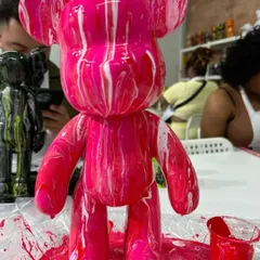 A close-up of a finished fluid bear, showcasing the bold pink and white marbled design. Each one is completely unique.