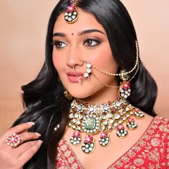 A close-up of a traditional bridal look created by one of our students. Notice the flawless base, sharp winged liner, and perfectly placed nath, all techniques we cover in detail.