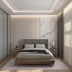 A guest bedroom designed with comfort and elegance in mind. The room features a full wall of sleek, handleless wardrobes, a subtle marble accent wall behind the bed, and soft, indirect lighting to create a welcoming and uncluttered retreat.